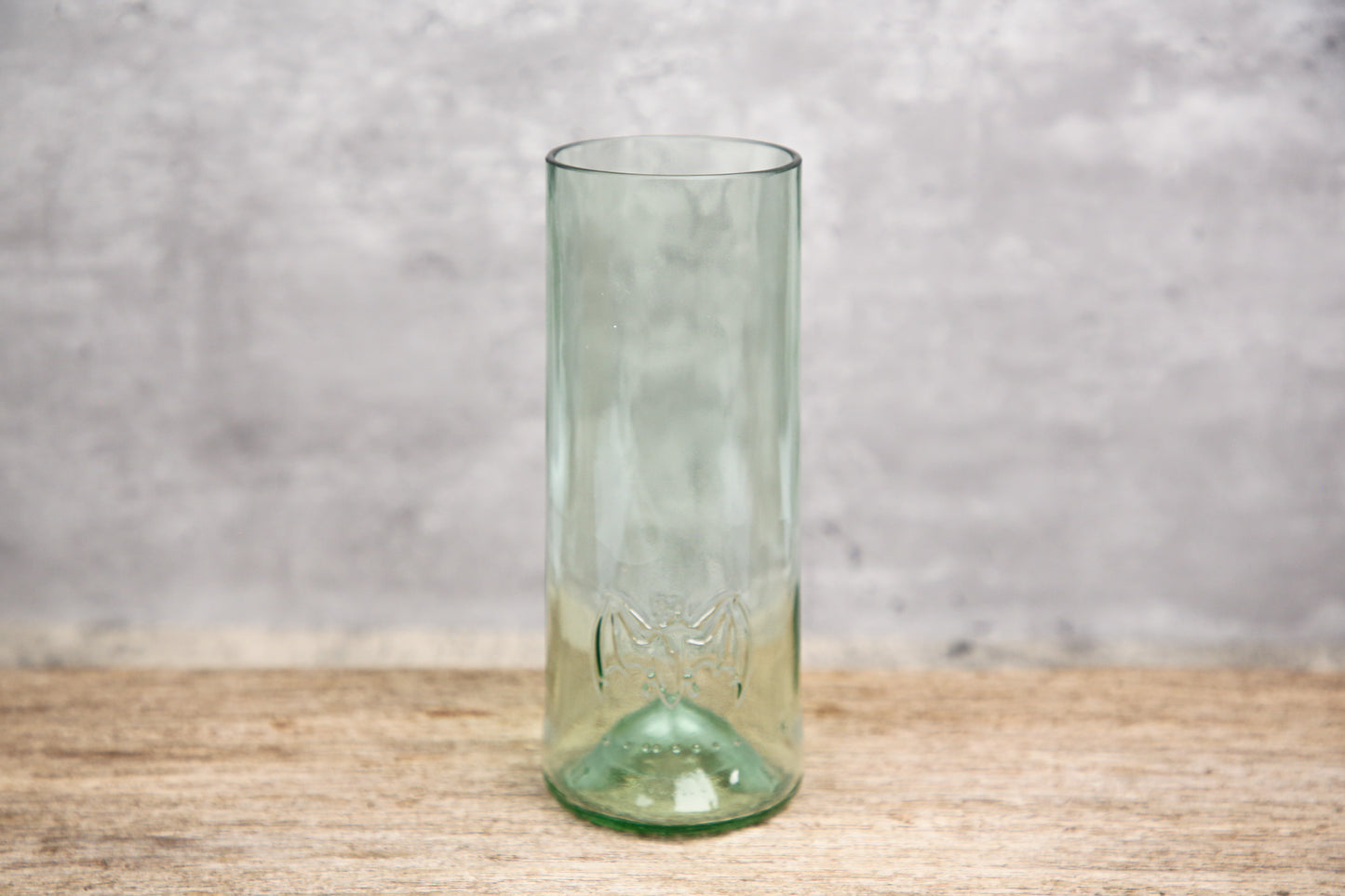 A clear green tinted pint glass with the iconic Bacardi bats symbol and the text 'Bacardi 1862' etched on it, displayed against a neutral background.