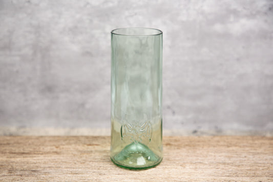 A clear green tinted pint glass with the iconic Bacardi bats symbol and the text 'Bacardi 1862' etched on it, displayed against a neutral background.