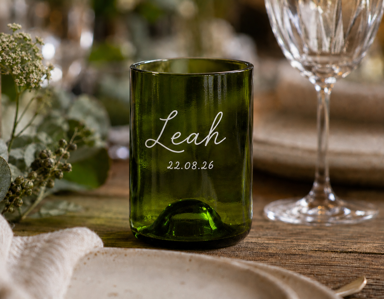 A personalised upcycled green glass tumbler with the name 'Leah' and date '22.08.
